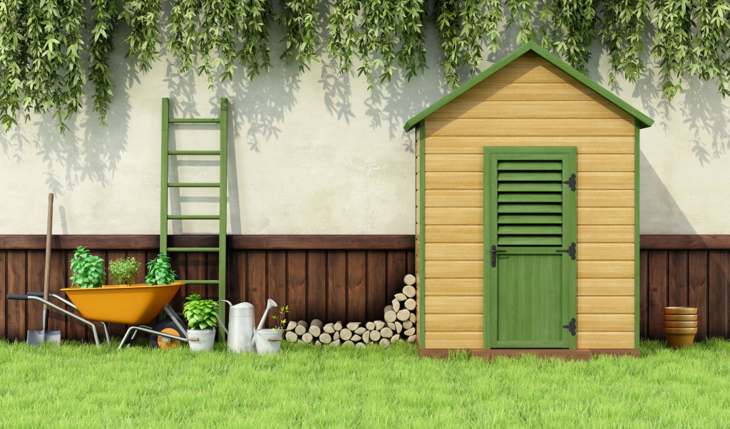 Garden with gardening  tools and wooden shed with closed door - 3D Rendering